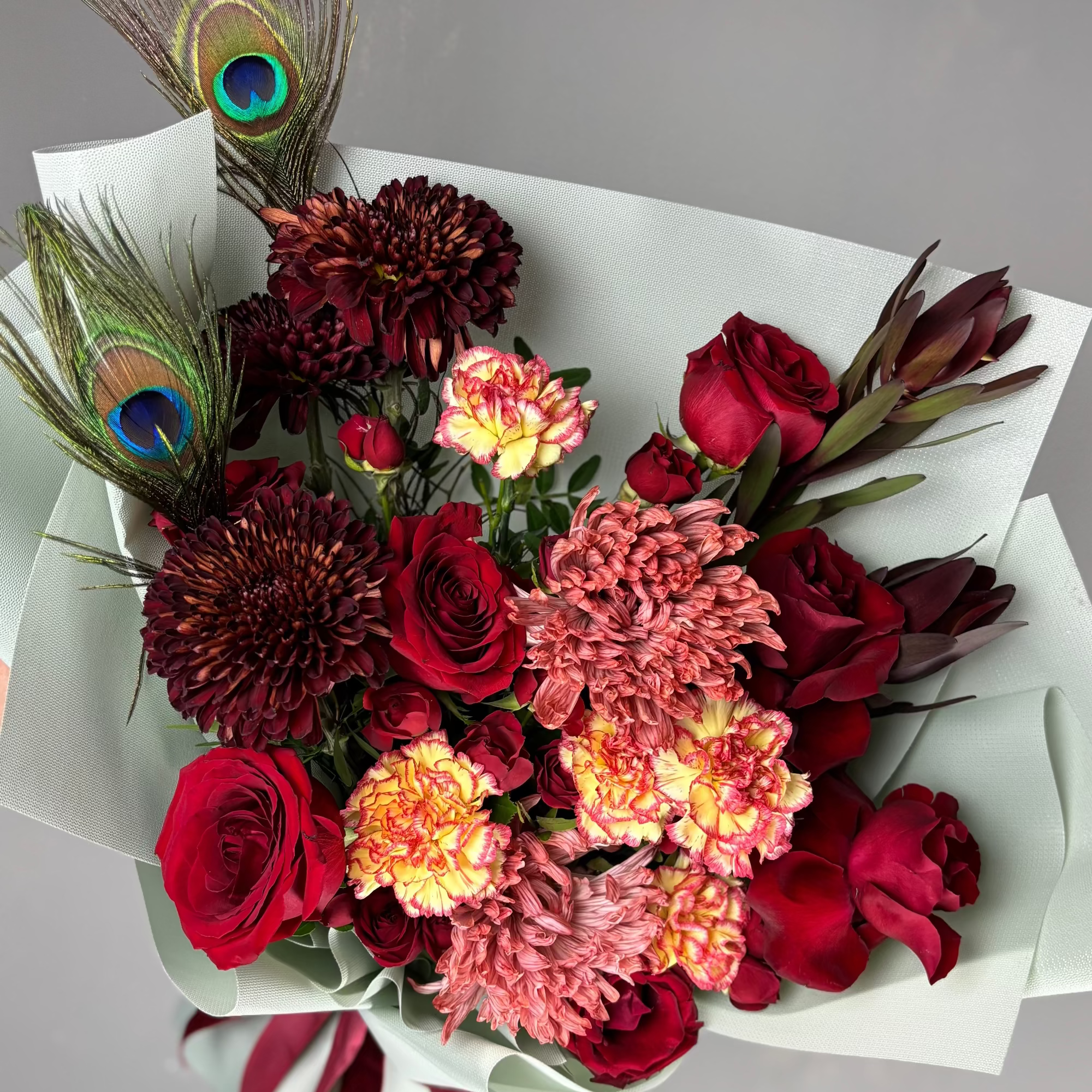 Bouquet of flowers with a peacock feather