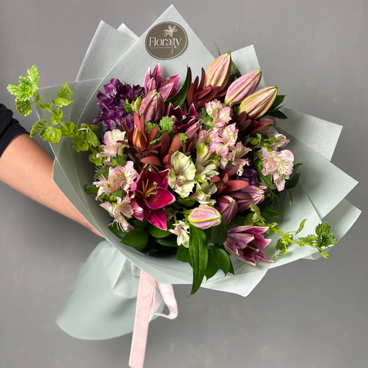 Bouquet of flowers with a visible brand label on a gray background