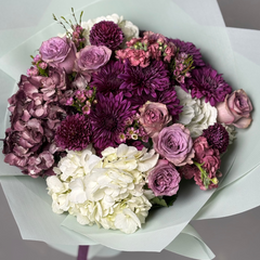 Bouquet of purple, pink, and white flowers on a gray background with 'Floraity' branding.