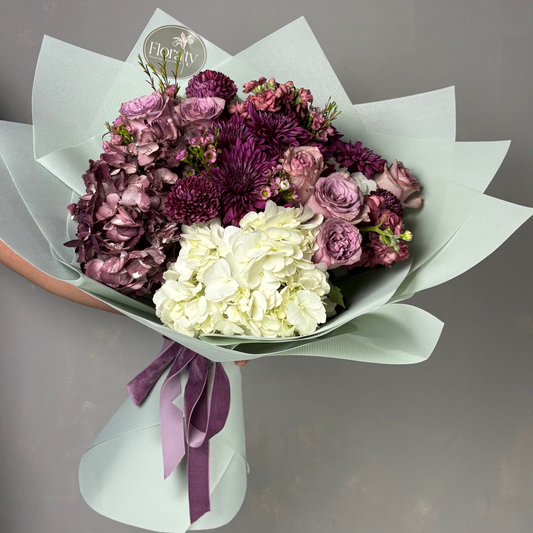 Bouquet of flowers with a purple ribbon on a gray background, featuring the brand 'Florist'.