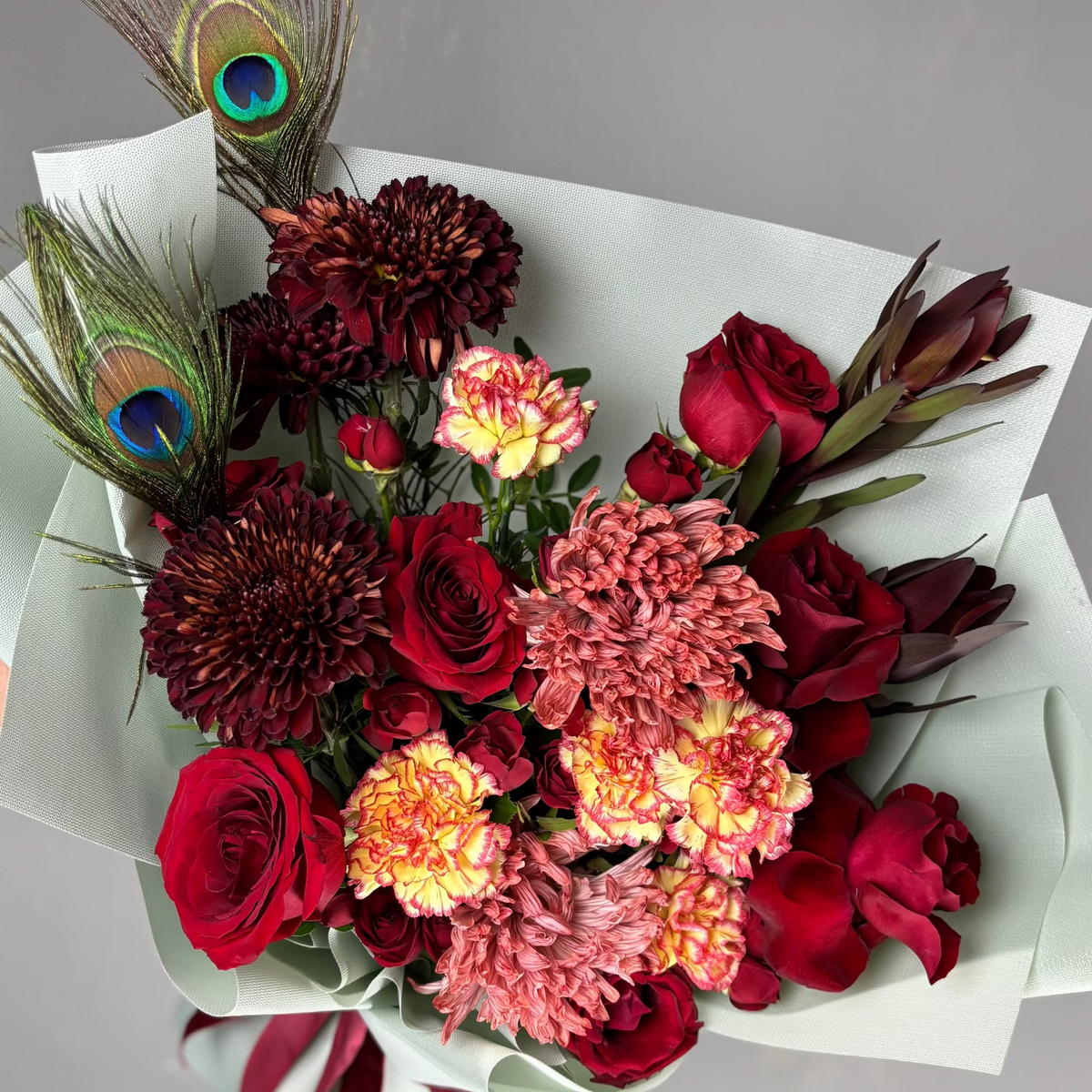 Bouquet of flowers with a peacock feather 