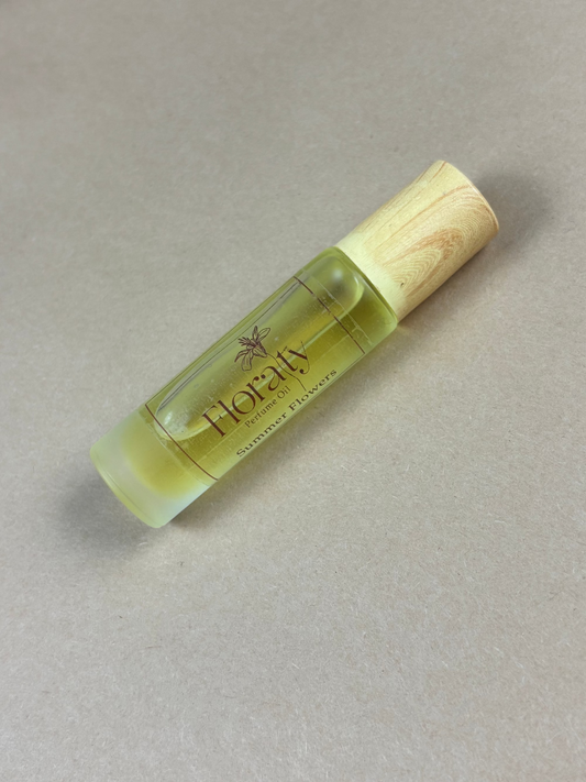 Small bottle of Floraly essential oil on a beige background