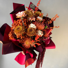Bouquet of flowers with orange and cream on a light gray background